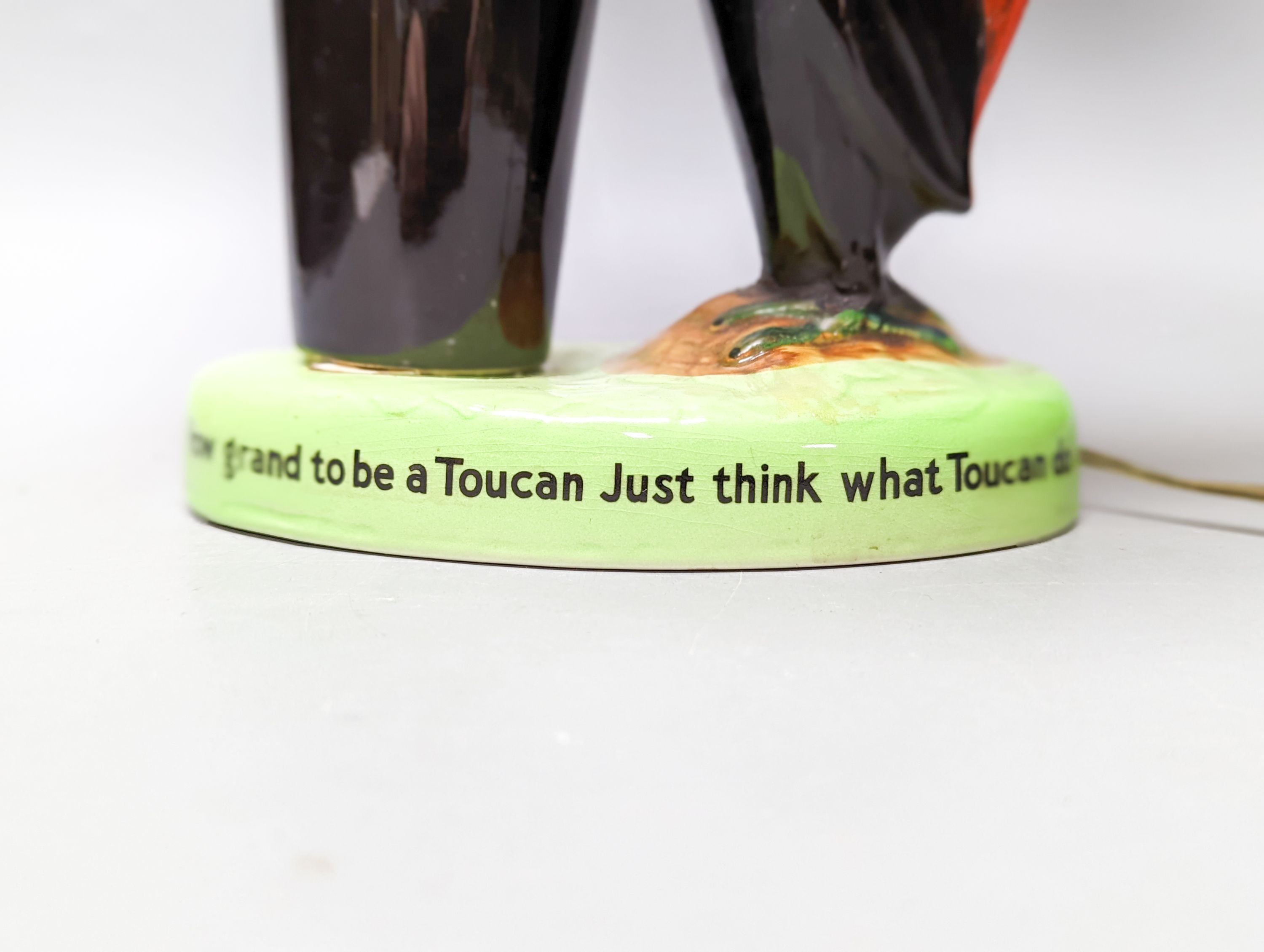 A Guinness toucan lamp, with original shade, tail repaired